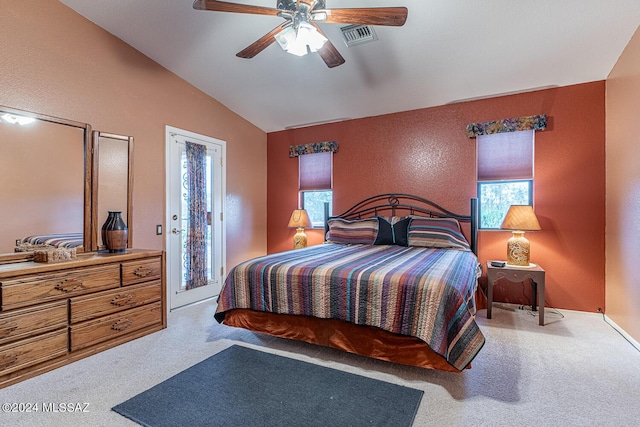 carpeted bedroom with visible vents, a textured wall, ceiling fan, access to outside, and vaulted ceiling