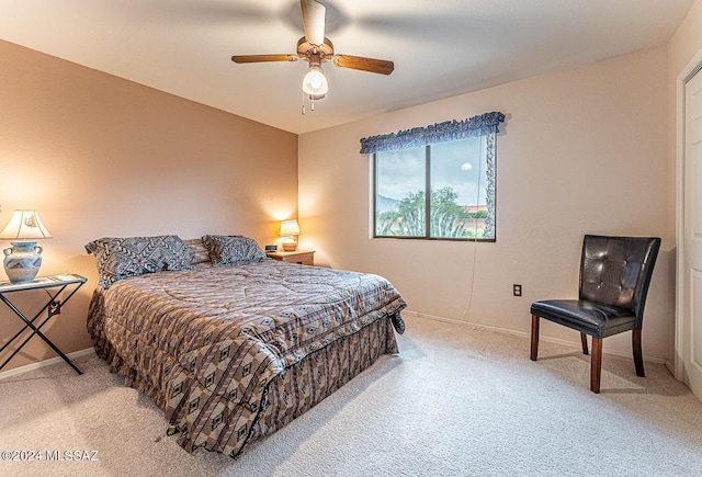 bedroom featuring baseboards, ceiling fan, and light colored carpet