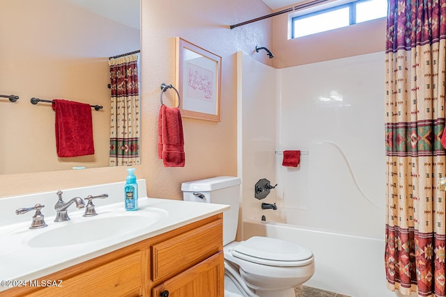 full bath featuring a textured wall, shower / bath combo, vanity, and toilet