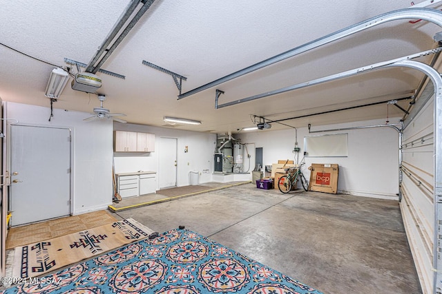 garage featuring water heater and a garage door opener