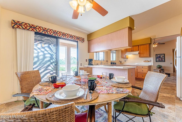 dining area with baseboards, vaulted ceiling, and a ceiling fan