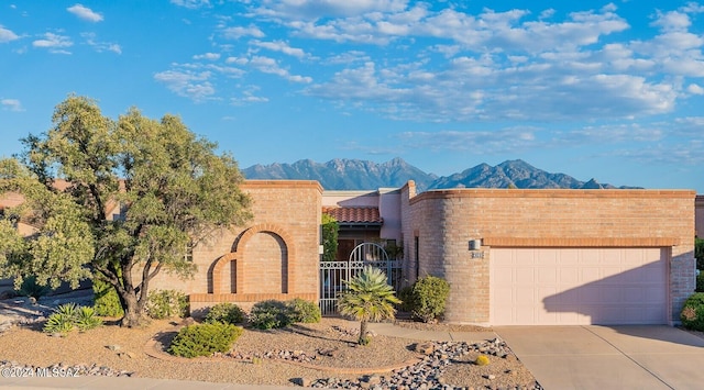 view of front of property with a mountain view and a garage