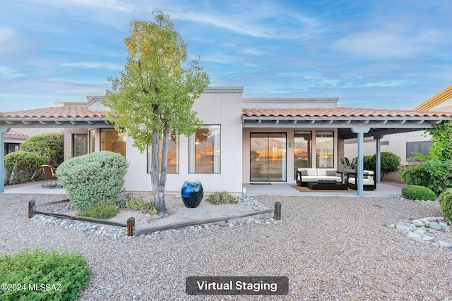 back of property with a patio and a carport