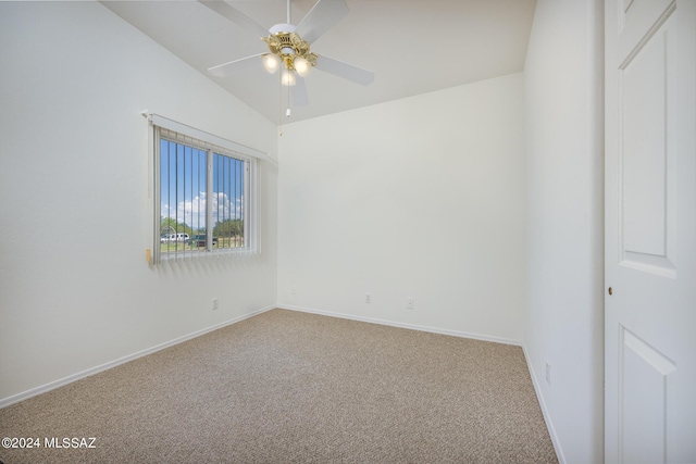 carpeted empty room with lofted ceiling and ceiling fan