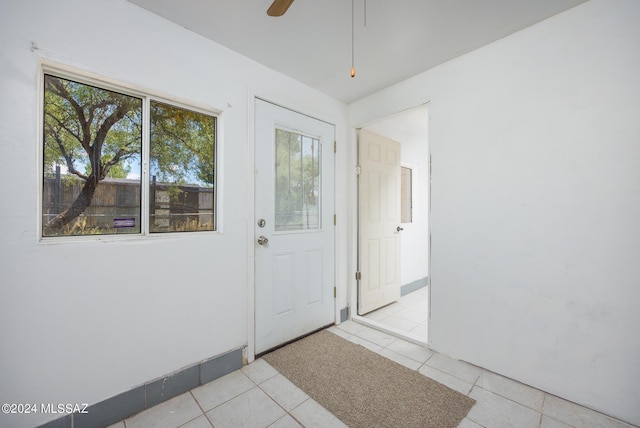 entryway featuring light tile patterned flooring and ceiling fan