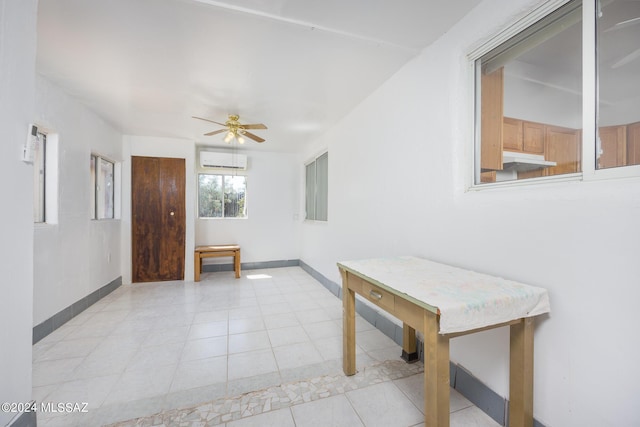 hall featuring a wall mounted air conditioner and light tile patterned floors