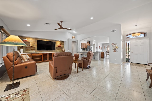 tiled living room with lofted ceiling and ceiling fan