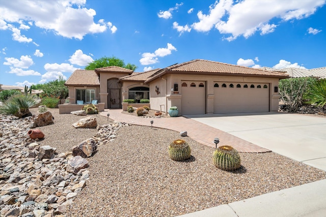 mediterranean / spanish-style house featuring a garage