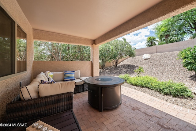 view of patio / terrace featuring an outdoor living space with a fire pit