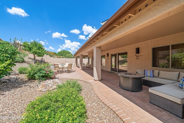 view of patio / terrace with an outdoor living space with a fire pit