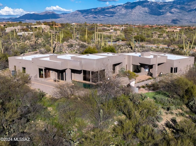 birds eye view of property with a mountain view