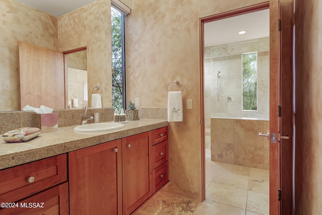 bathroom with vanity and tiled shower