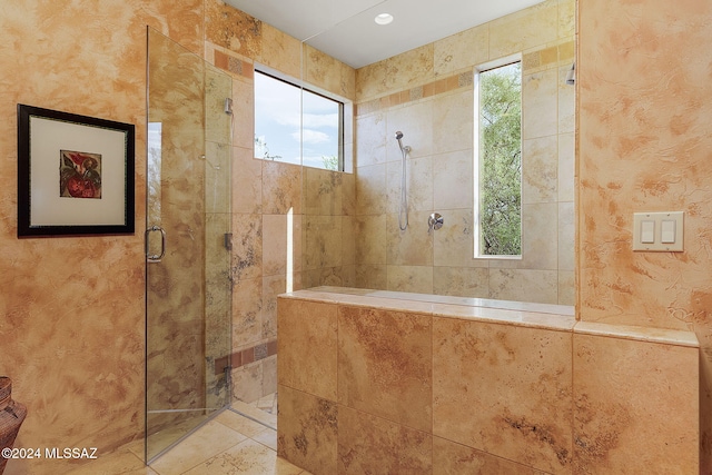 bathroom with an enclosed shower and a wealth of natural light