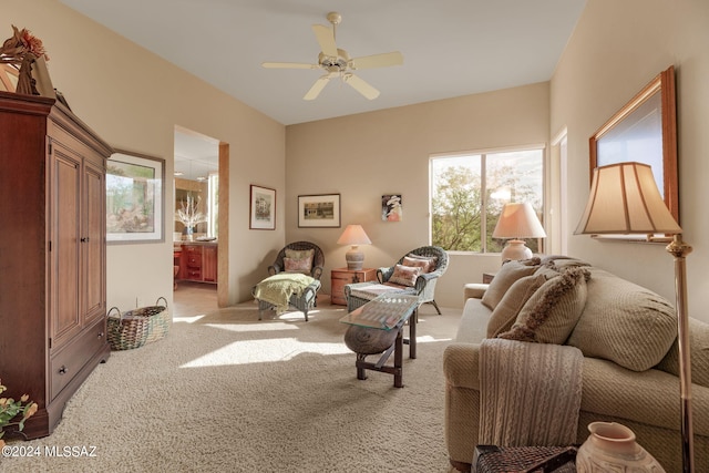 carpeted living room featuring ceiling fan