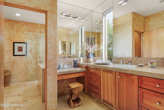 bathroom with vanity, a healthy amount of sunlight, and walk in shower