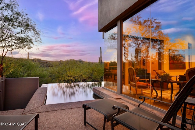 view of patio terrace at dusk