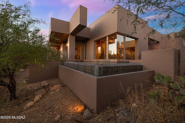 view of back house at dusk