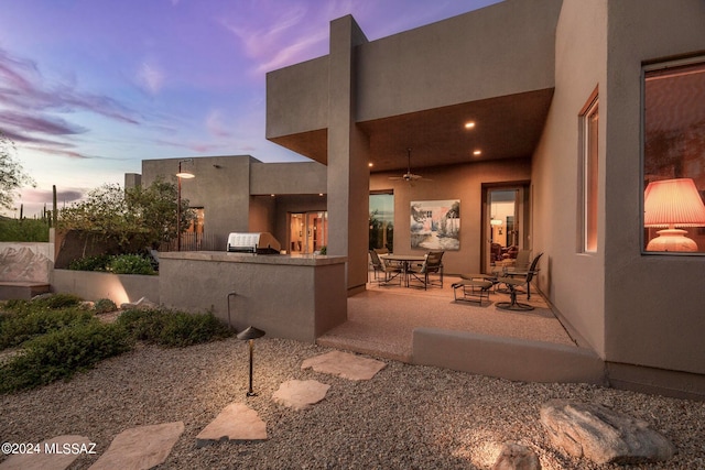 patio terrace at dusk with an outdoor kitchen