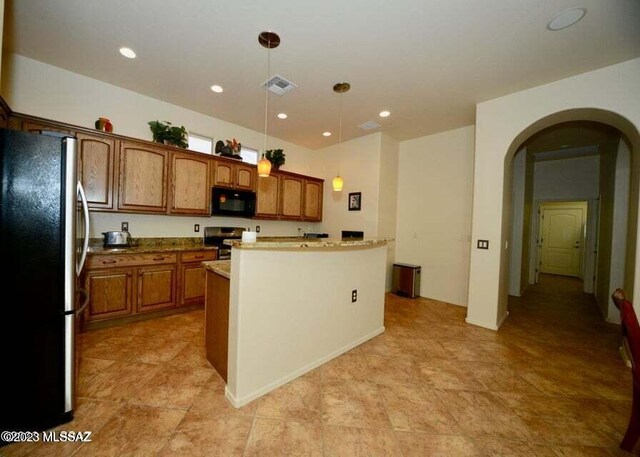 kitchen featuring stainless steel fridge, pendant lighting, dishwasher, and light tile patterned floors