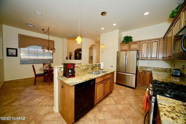 kitchen featuring light tile patterned flooring, an inviting chandelier, pendant lighting, and light stone counters