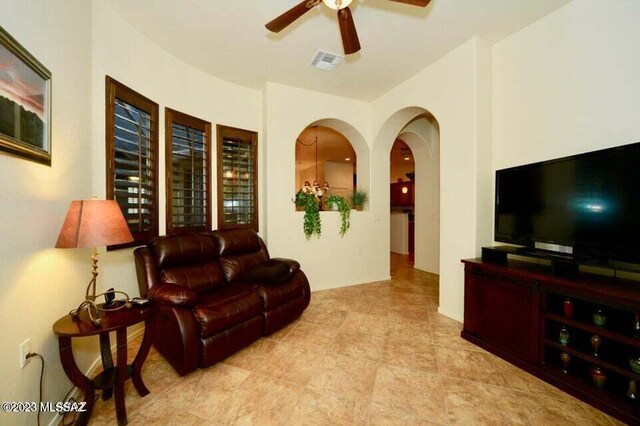 living room with light tile patterned flooring and ceiling fan