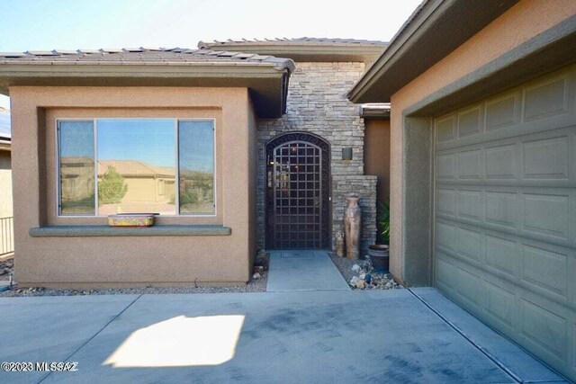 view of exterior entry featuring a garage