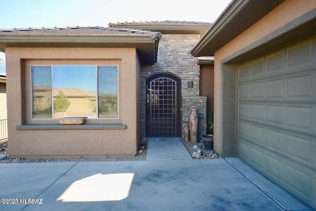 view of exterior entry with a garage