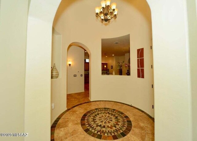 interior space featuring an inviting chandelier and light tile patterned floors