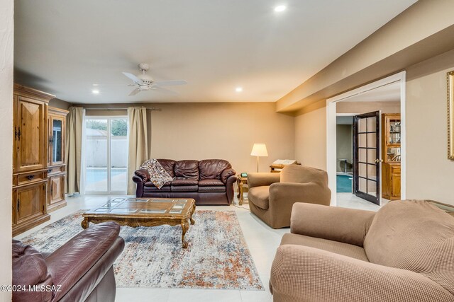 living room featuring light tile patterned flooring and ceiling fan