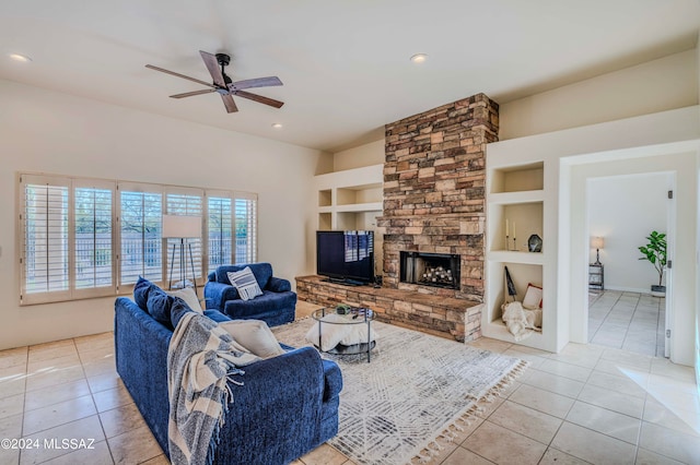 living room featuring built in features, a fireplace, light tile patterned floors, and ceiling fan