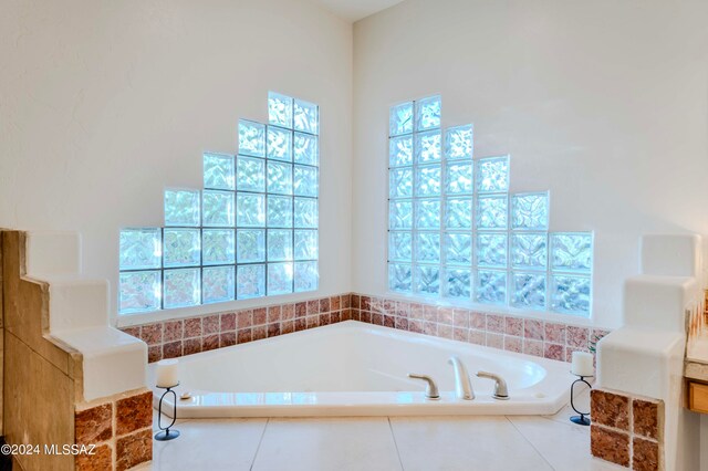 bathroom with a relaxing tiled tub