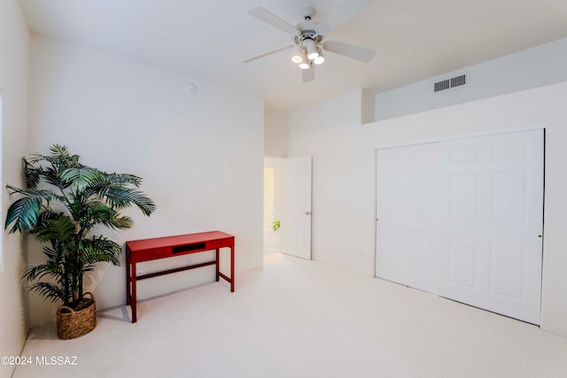 interior space with ceiling fan and carpet