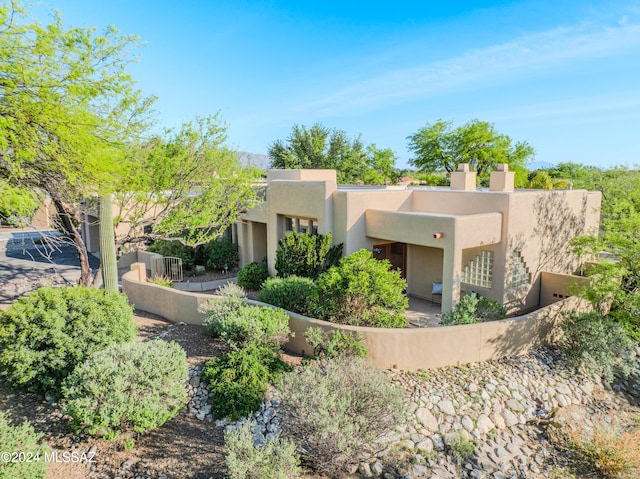 pueblo-style home with a balcony