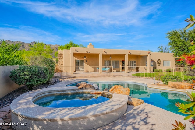 view of pool with an in ground hot tub and a patio area