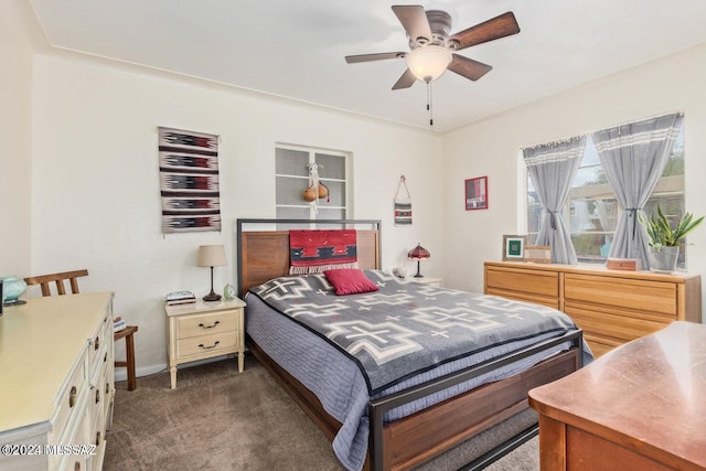 bedroom with ceiling fan and dark colored carpet