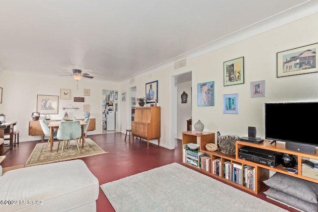 living room with ceiling fan, ornamental molding, and wood-type flooring