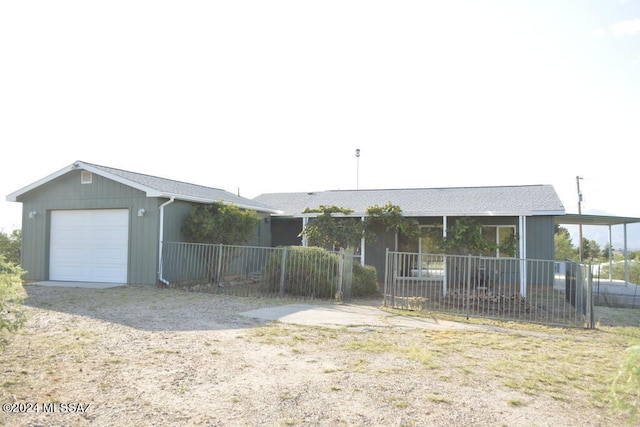 single story home with an outbuilding, a porch, and a garage