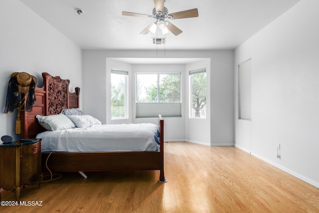 bedroom with ceiling fan and light hardwood / wood-style floors