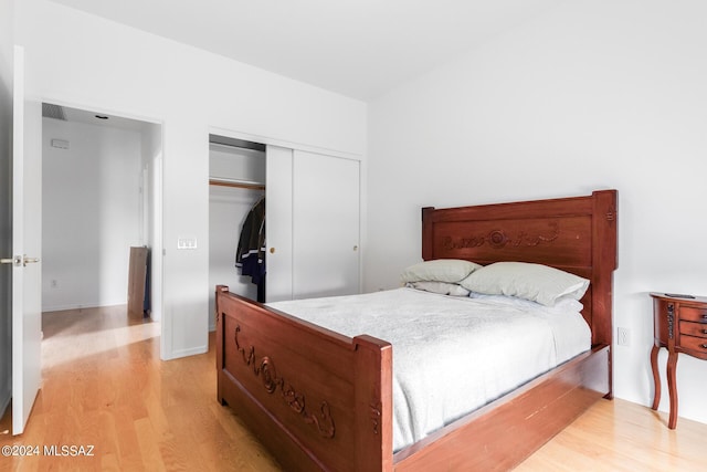 bedroom featuring a closet and light wood-type flooring