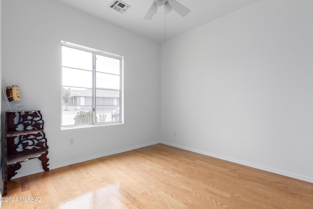 spare room with ceiling fan and light wood-type flooring