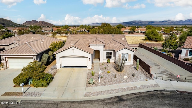 view of front facade featuring a garage and a mountain view