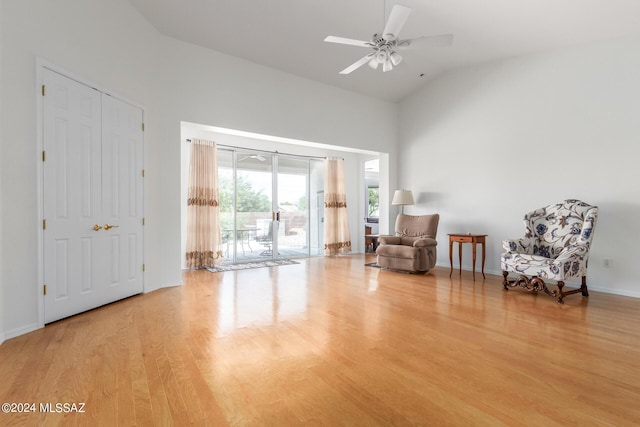 unfurnished room featuring ceiling fan, high vaulted ceiling, and light wood-type flooring