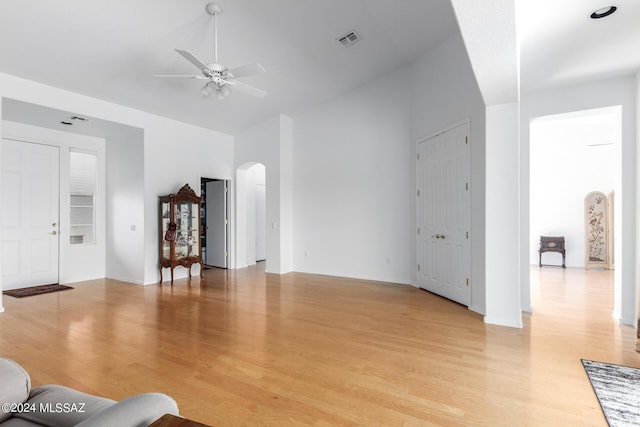 living room featuring light hardwood / wood-style flooring and ceiling fan