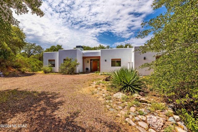 pueblo revival-style home with stucco siding