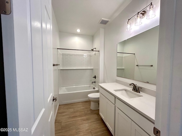 full bathroom with vanity, wood-type flooring, shower / washtub combination, and toilet