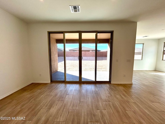 empty room with light hardwood / wood-style flooring