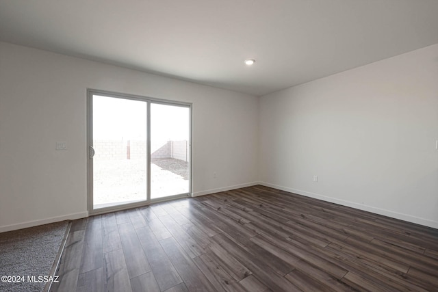 empty room featuring a wealth of natural light and hardwood / wood-style floors