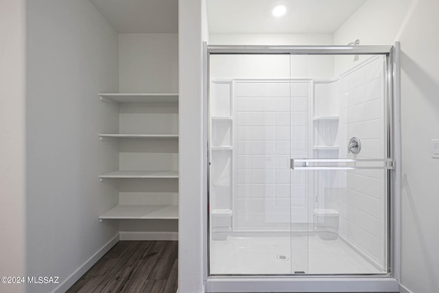 bathroom featuring hardwood / wood-style flooring and an enclosed shower