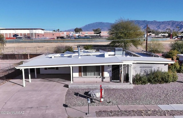 view of front of house with a carport and a mountain view