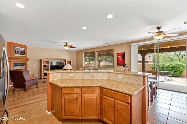 kitchen with plenty of natural light, a center island, and ceiling fan